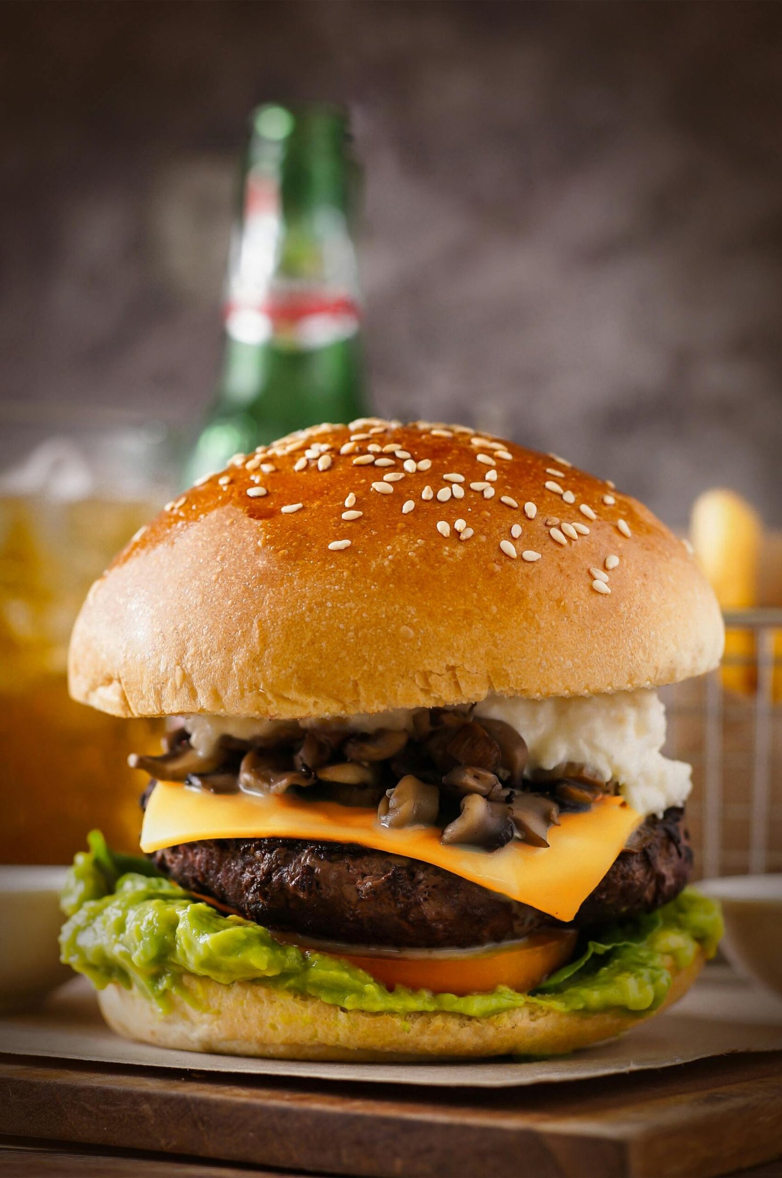 Close-up of a gourmet cheeseburger with mushrooms, lettuce, and cheddar, perfect for fast food lovers.